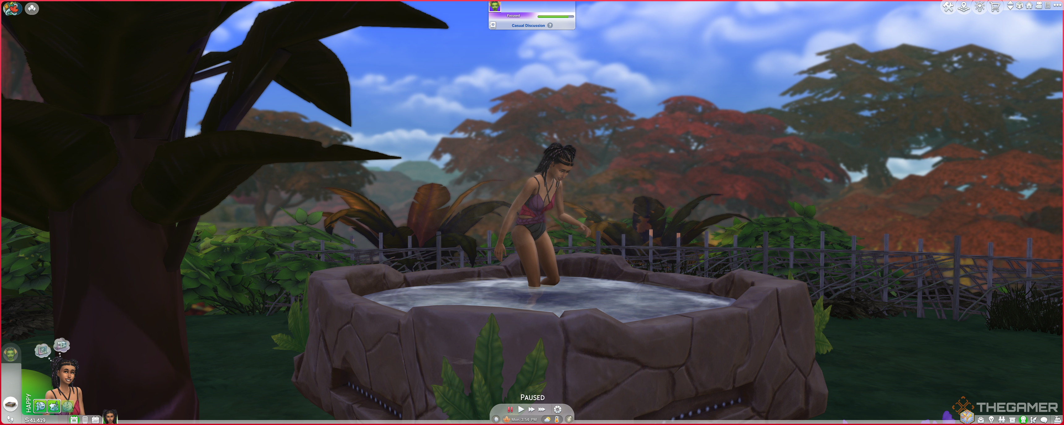 A Sim entering a hot tub in the flowing fronds swimwear.