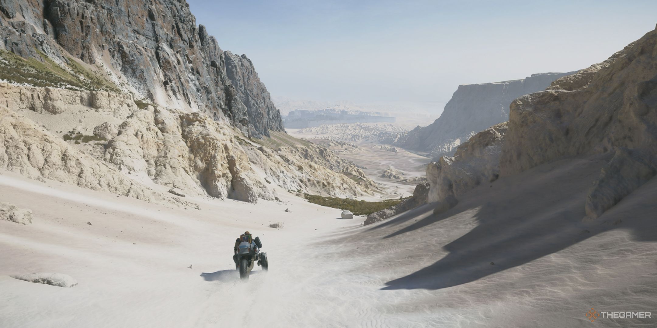 Death Stranding 2 Sam riding bike down valley in Mexico.