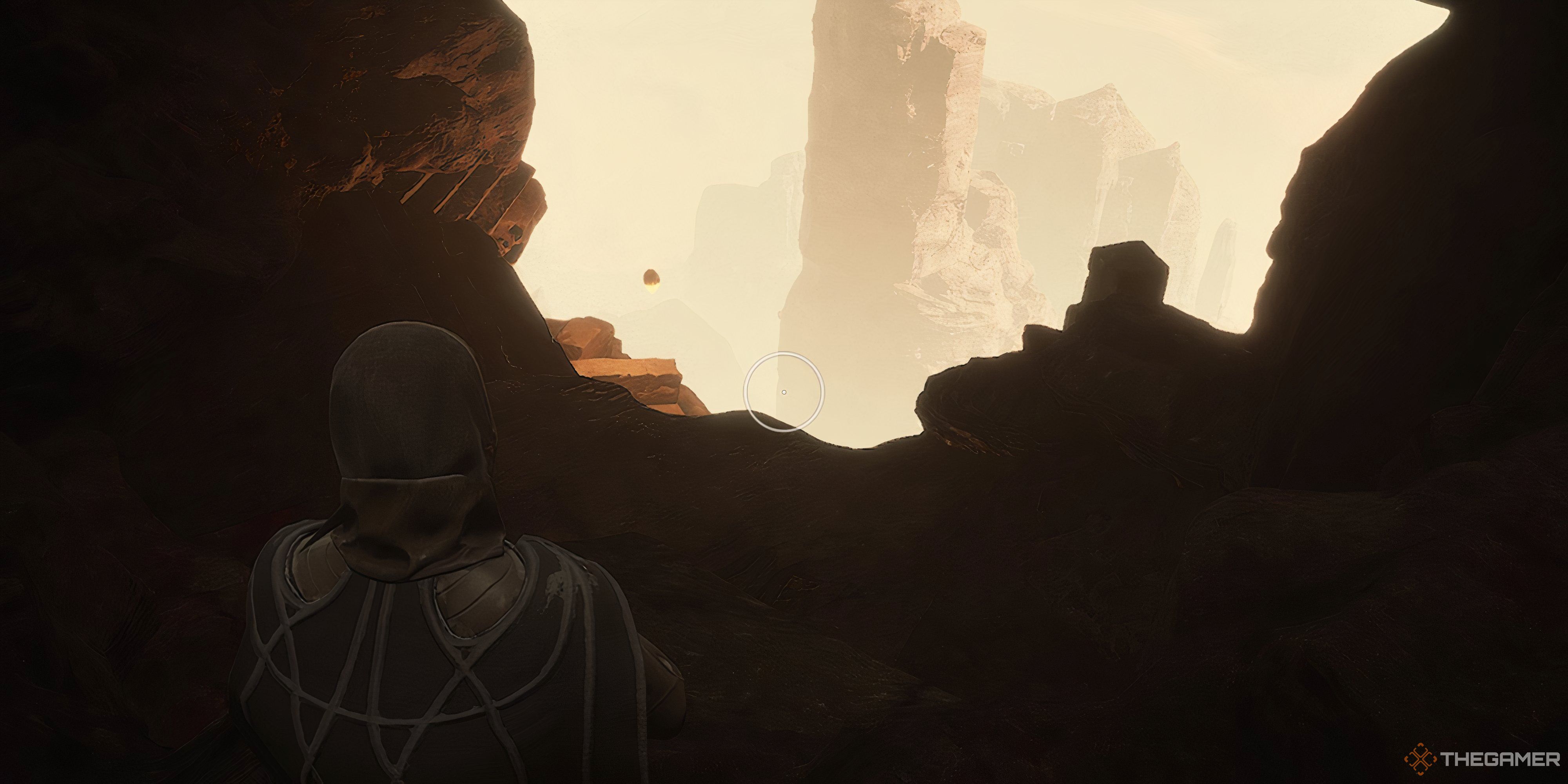 Player inside a rock pillar looking outside with another rock pillar on the other side in Dune: Awakening.