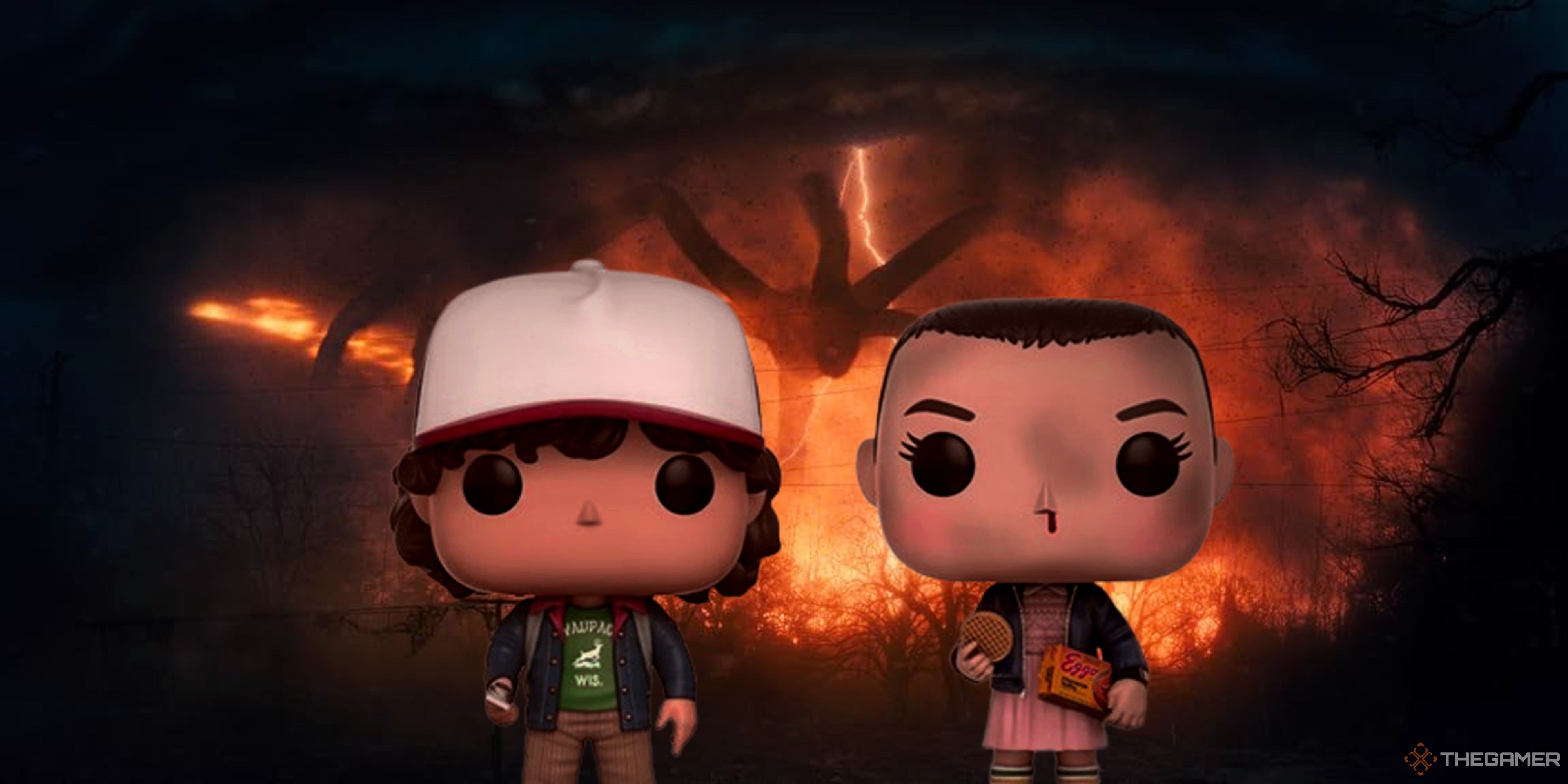 dustin and eleven funko pops standing in front of the mindflayer in stranger things.