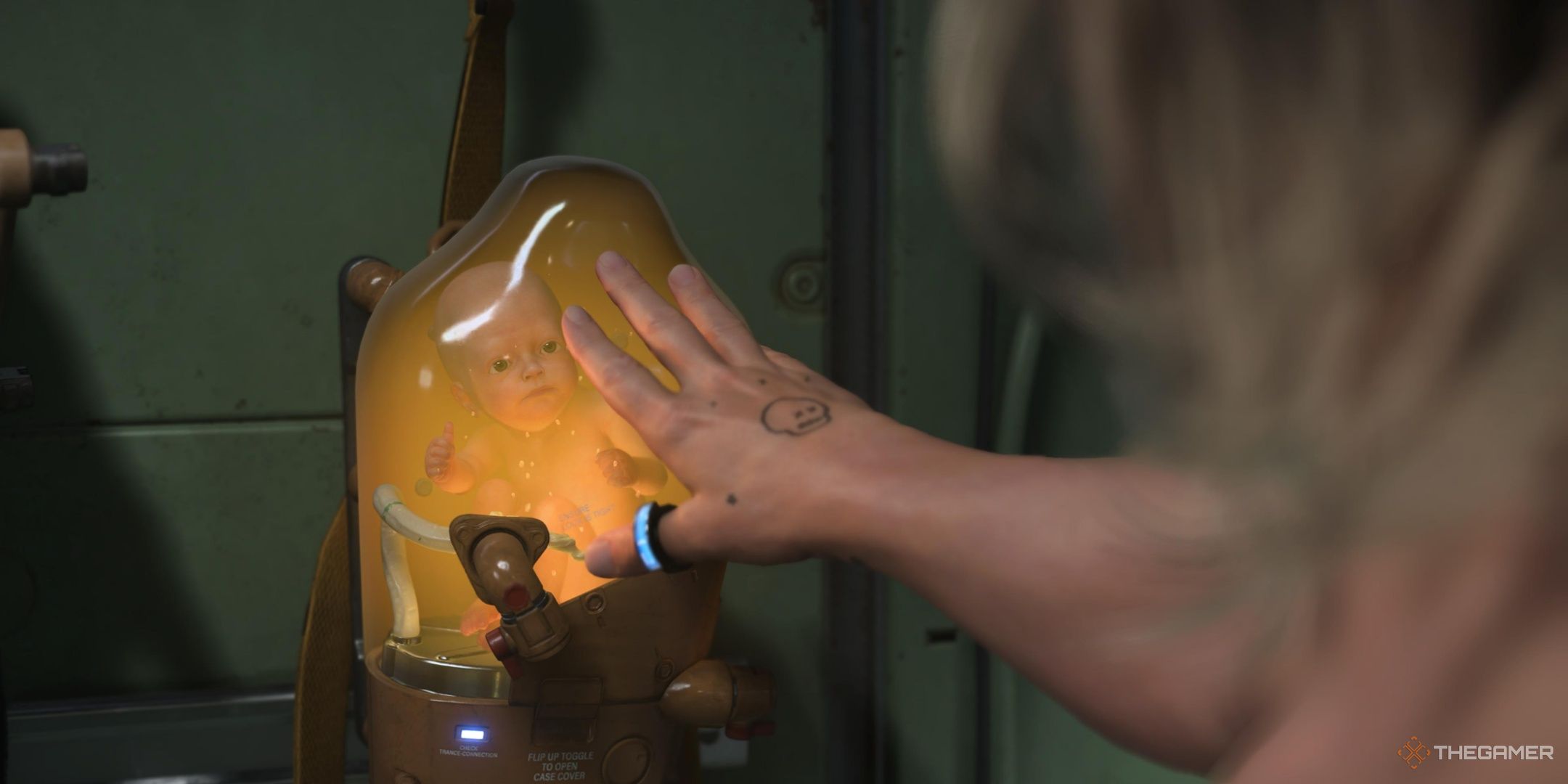Sam reaching his hand out to Lou in a BB pod in death stranding 2.
