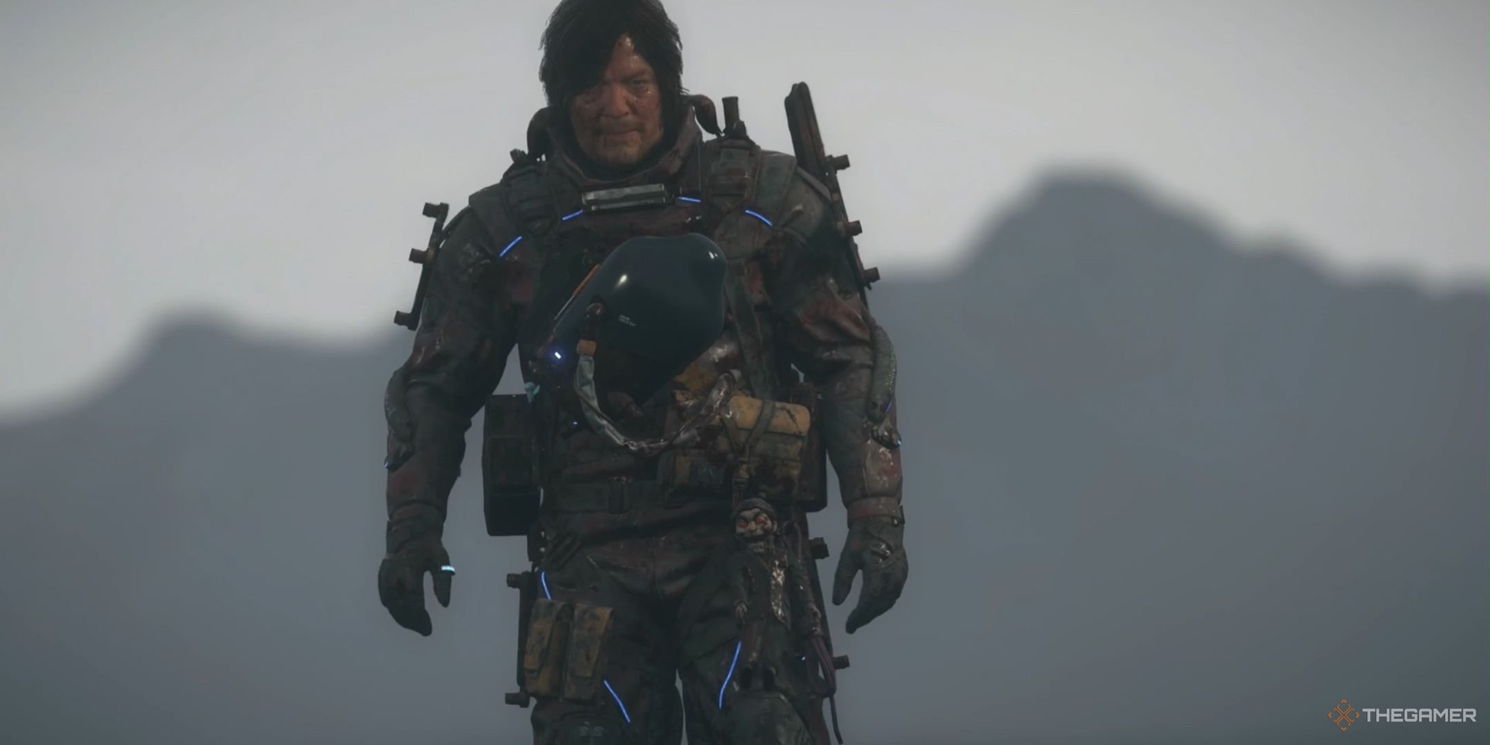 Sam walking with the harmonica equipped in death stranding 2 on the beach.