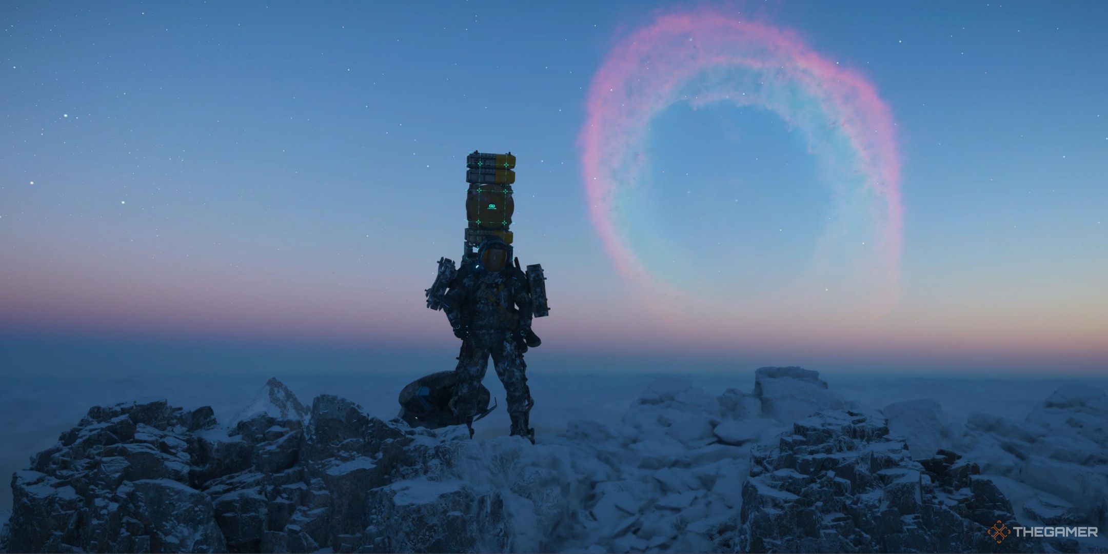 Sam looking at the camera from the toip of a mountain, carrying cargo and a coffin board in Death Stranding 2.