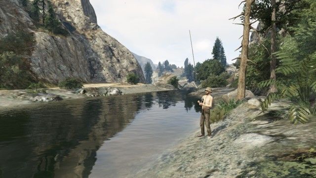 a man fishing in a river at the bottom of a canyon in gta 5