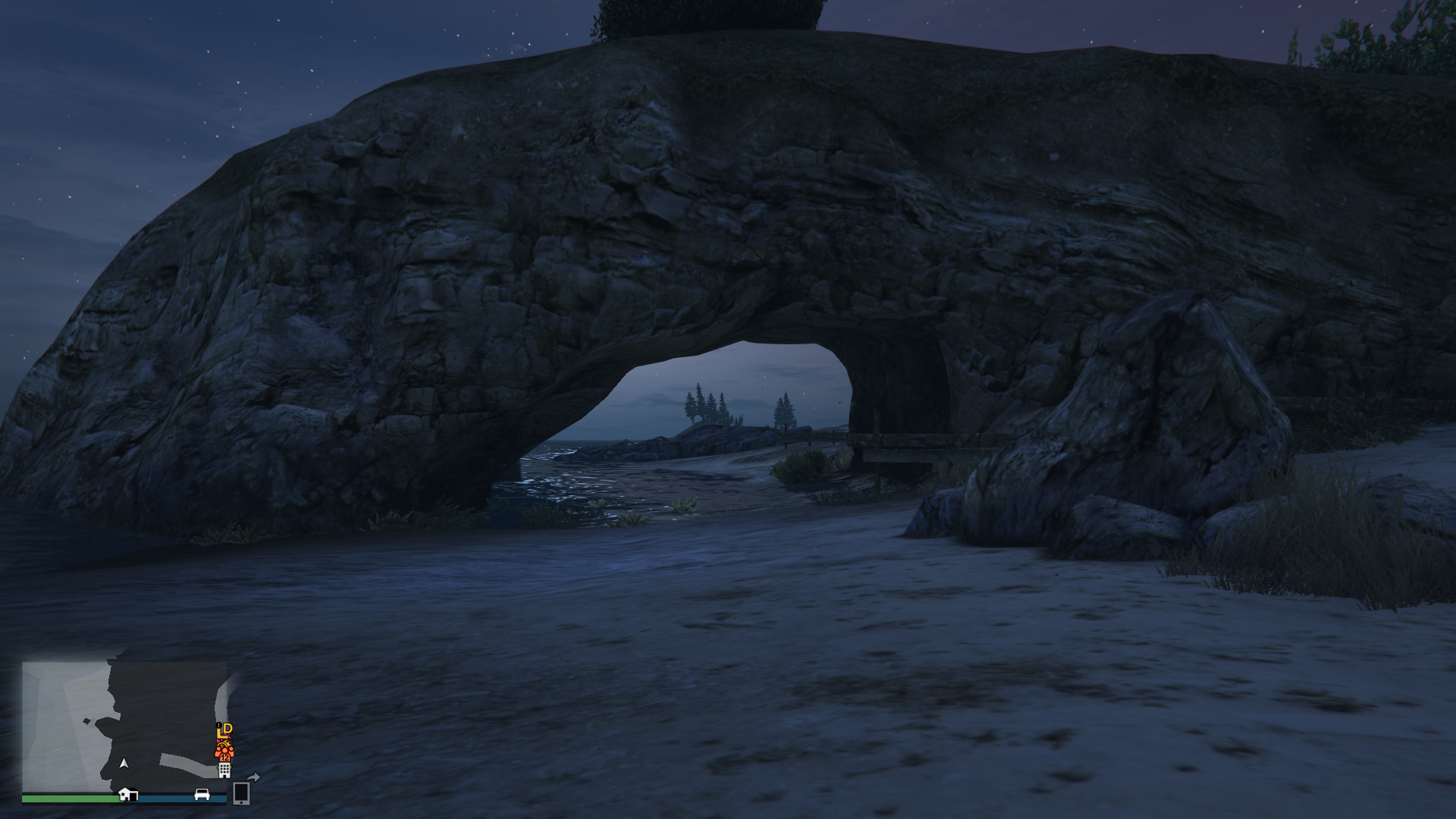 a cove with a lovely arched rock formation over a sandy beach in gta 5