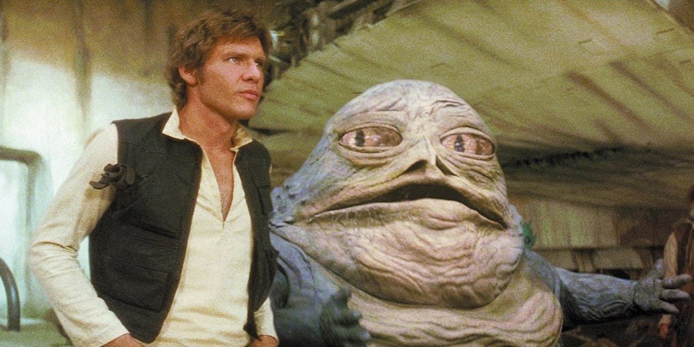 Han Solo and Jabba standing next to each other at Jabba's Palace.