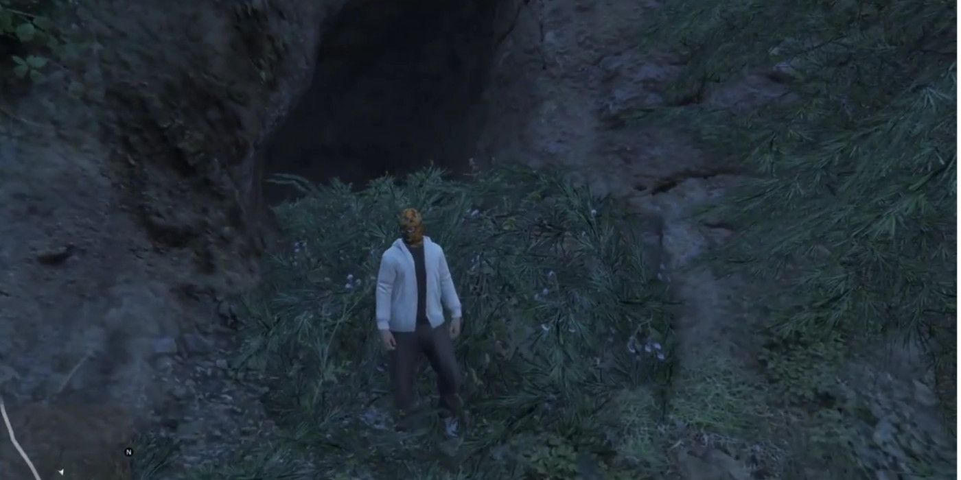 a man outside a hillside cave in gta 5