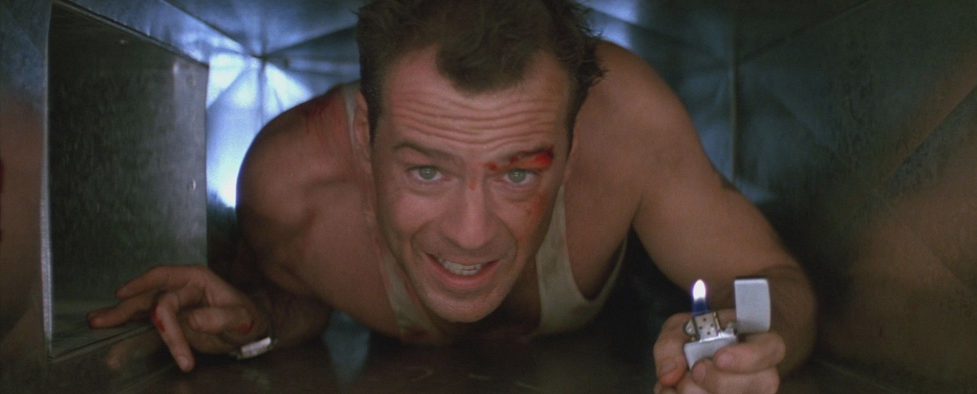 Bruce Willis as John McClane in Die Hard crawling through the vent