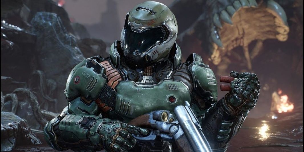 Doom Slayer loading the Super Shotgun with the shells he has in his left hand.