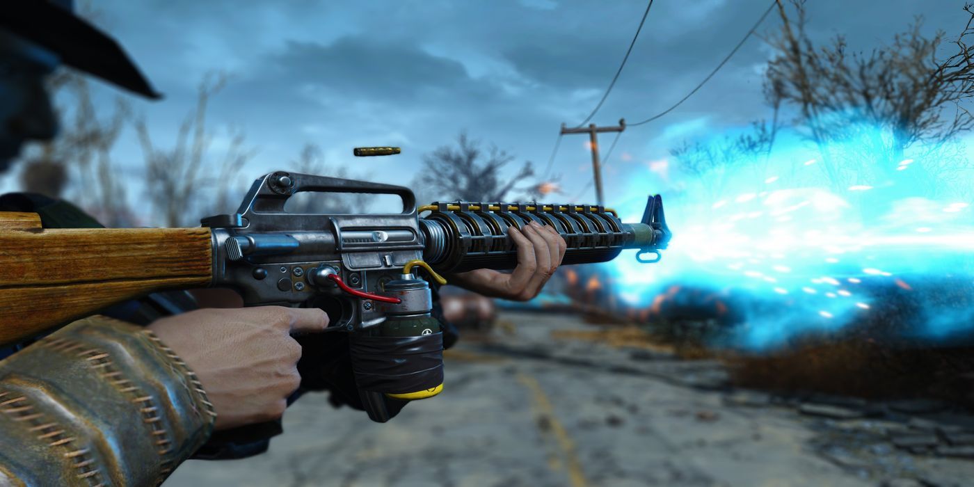 The sole survivor fires a blast of blue energy from their assault rifle in Fallout 4.