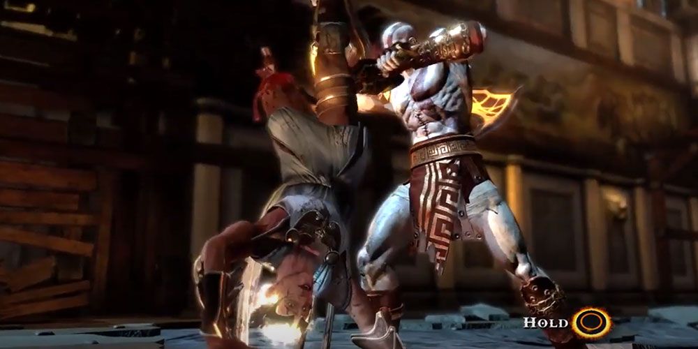 Kratos ripping Hermes' right leg in God of War 3