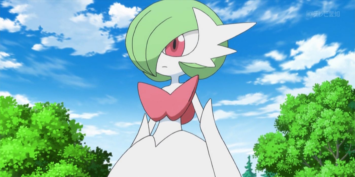 Mega Gardevoir stands with its hands at its sides in front of some trees  in the Pokemon anime.