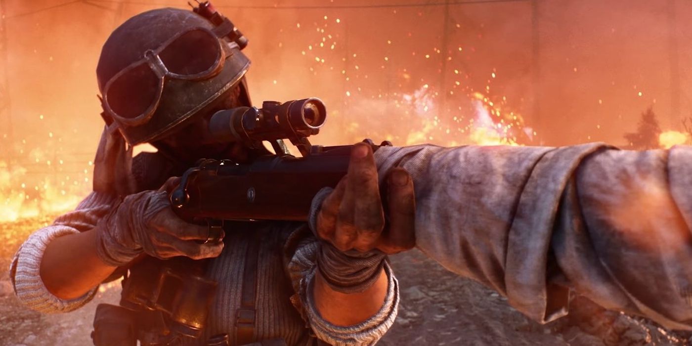 Battlefield 5 Feuersturm-Soldat, der mit seinem Gewehr zielt und Feuer hinter sich hat