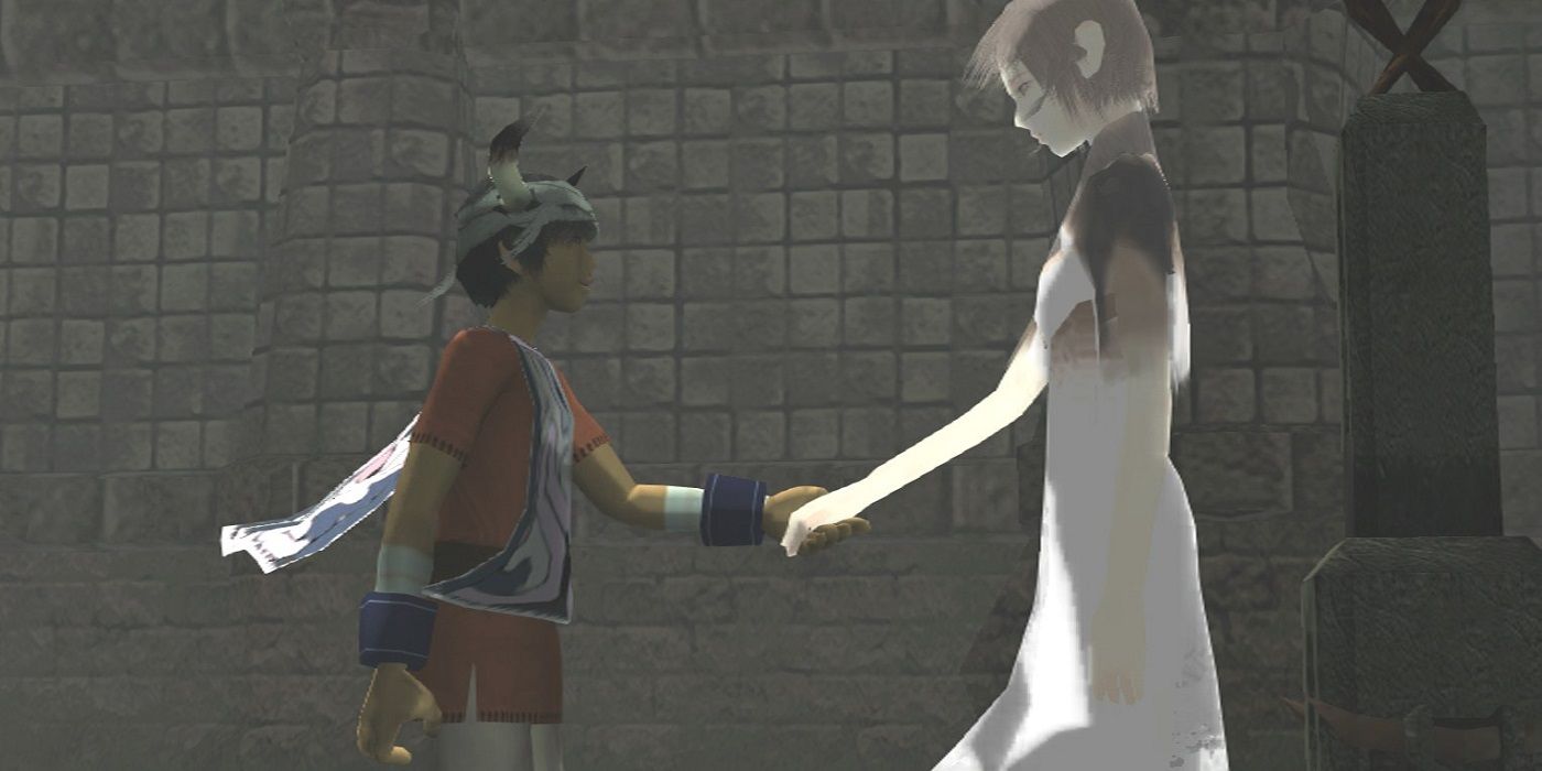 Ico and Yorda holding hands while looking at each other.