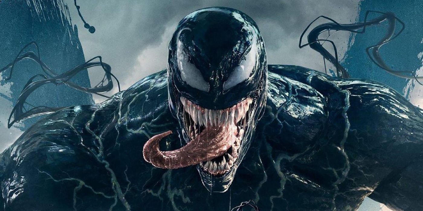 Venom sticking his tongue out to the camera while black tendrils swing around him