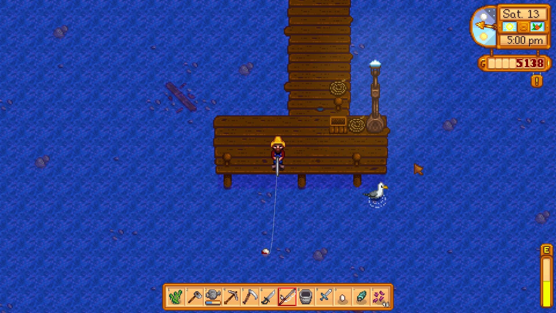 a player fishing in the ocean off of a dock 