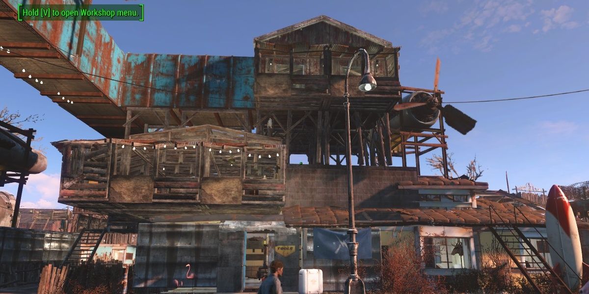 A settlement building in Fallout 4, houses stacked on top of each other, constructed from salvaged materials.