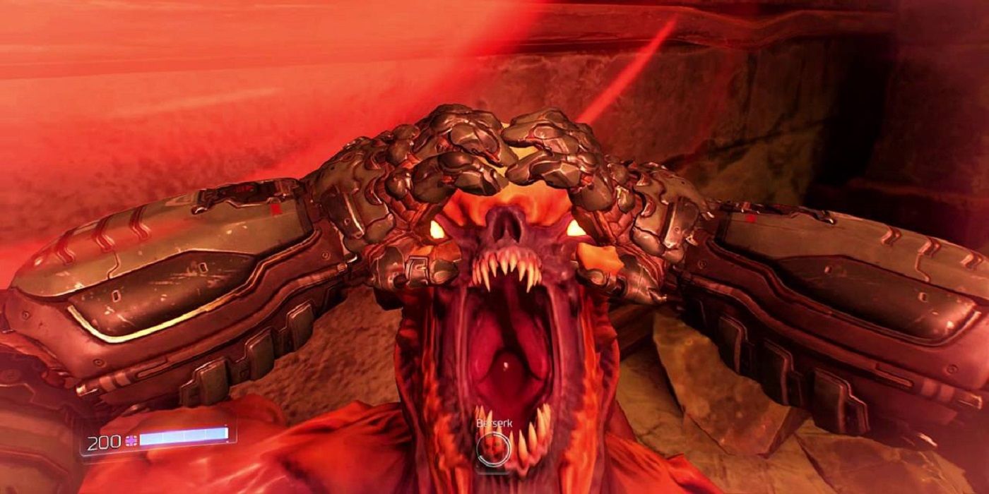 Doom Slayer about to rip apart a demon's face as part of the glory kill mechanic in Doom 2016.