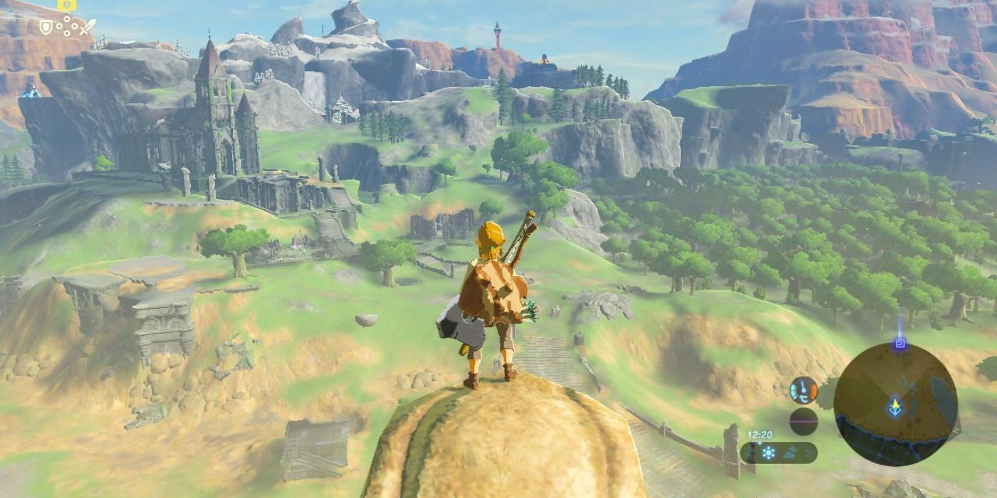 Link standing on the edge of a cliff and looking over the gorgeous mountainous landscape filled with lush green in Breath of the Wild.