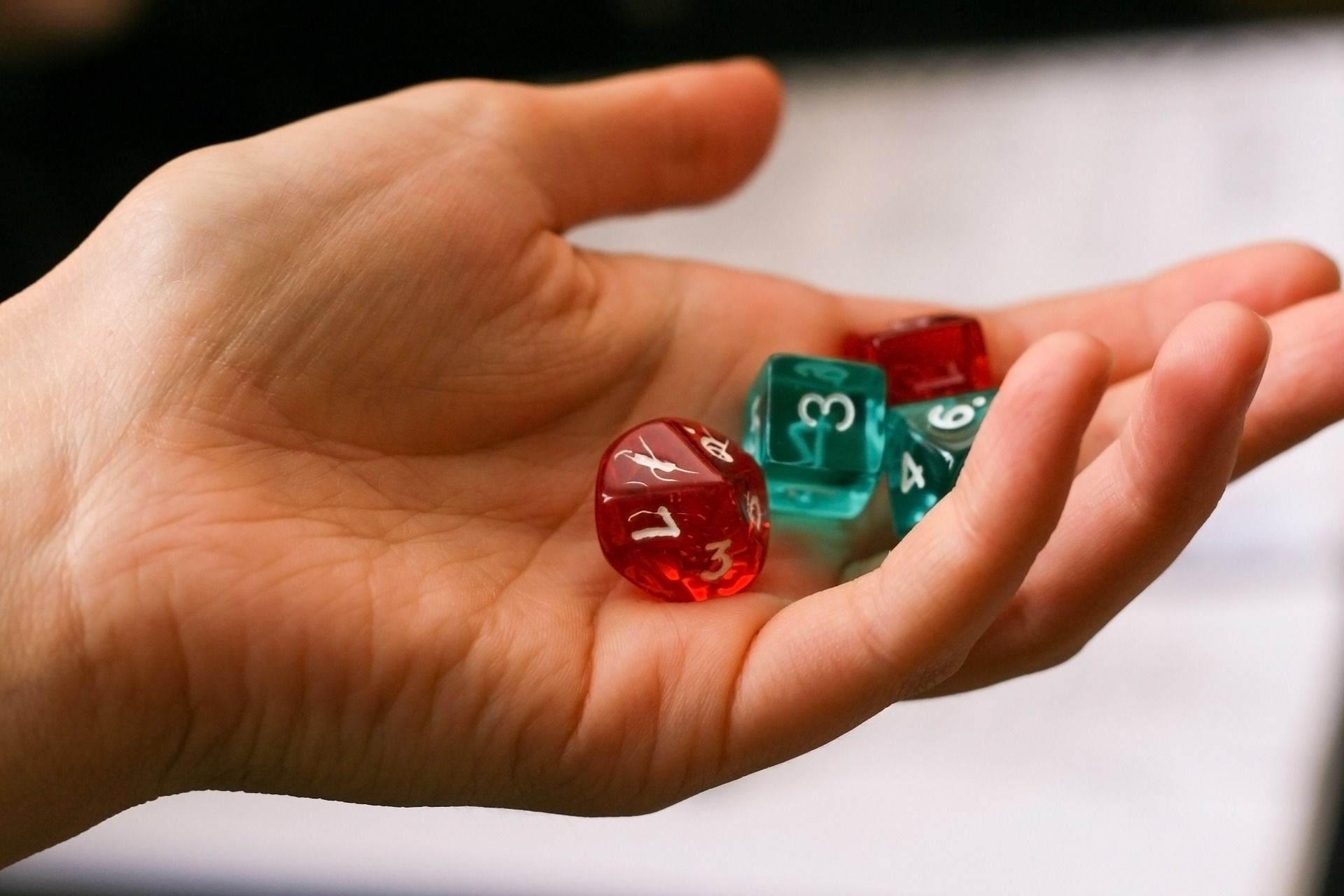 Hand holding Green and Red Dice