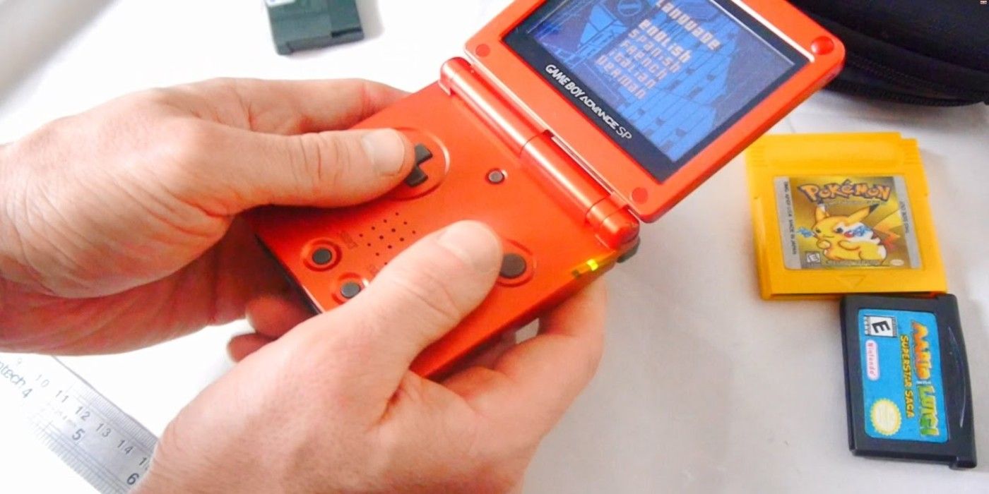 Game Boy Advance SP being used with games on table behind