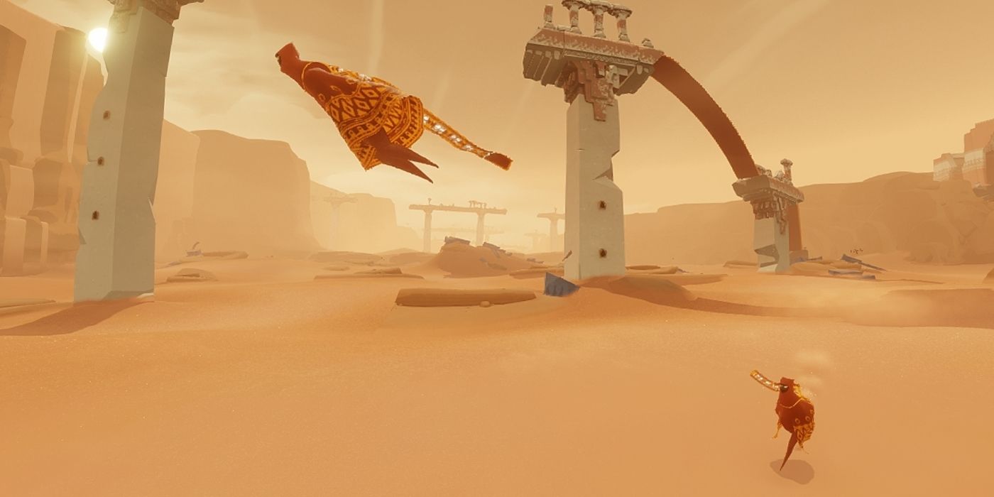 a wide shot of two players in Journey one floating through the air while the other follows on foot behind with ruined towers looming in the distance