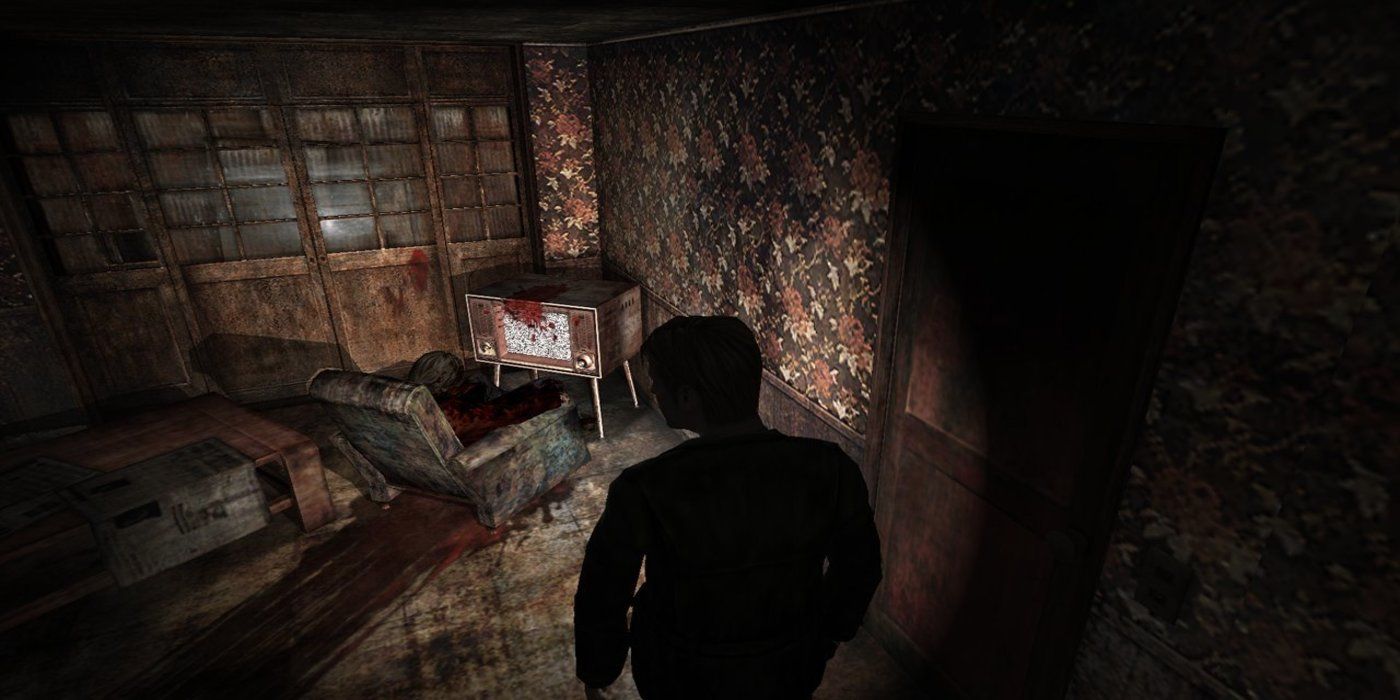 a wide, overhead shot of the player walking through an eerie location with a bloodstained TV and armchair in front of them