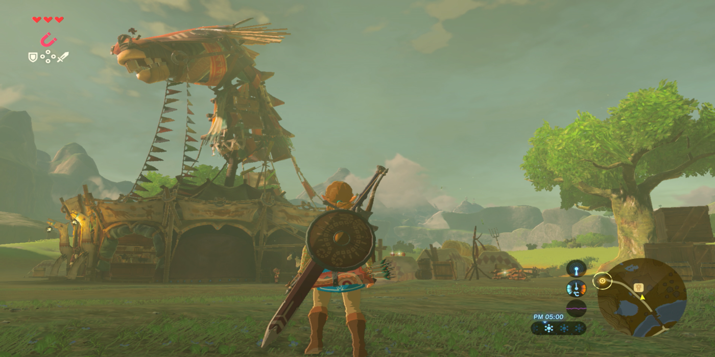 a wide shot of Link from The Legend of Zelda: Breath of the Wild stood outside of a stable with a large tree to the right and mountains looming in the distance