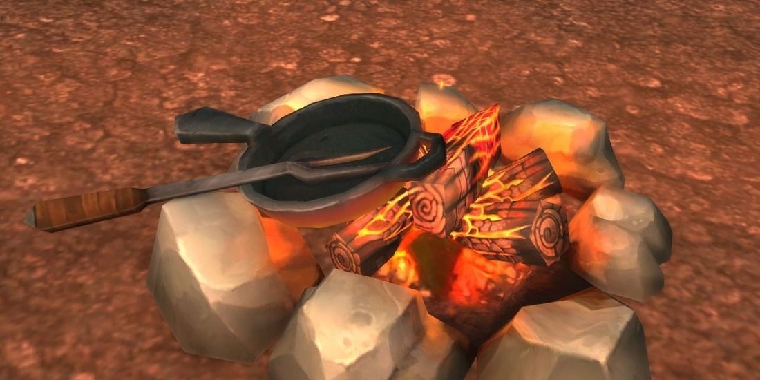 A frying pan and fork placed on a bonfire in World of Warcraft
