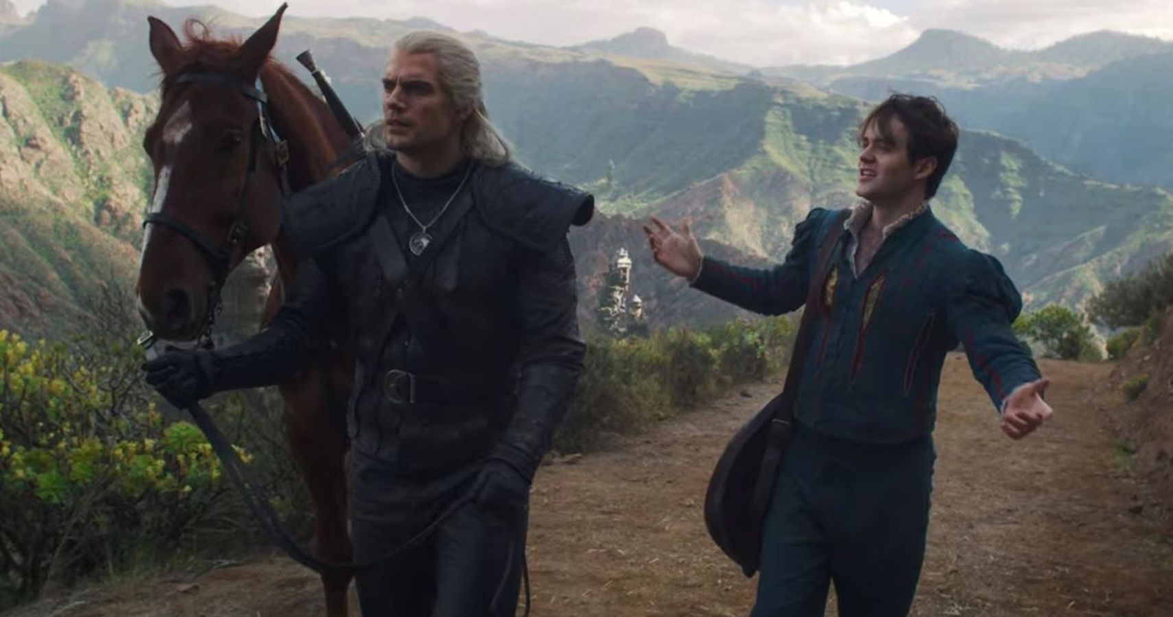 geralt and jaskier walking along with a horse.