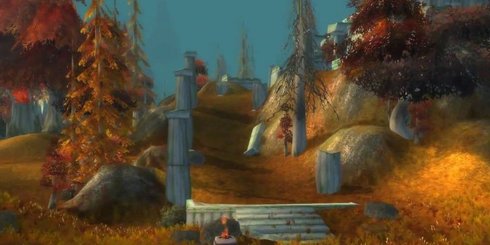 A road in Azshara with red trees and ruined pillars, from World of Warcraft Classic.