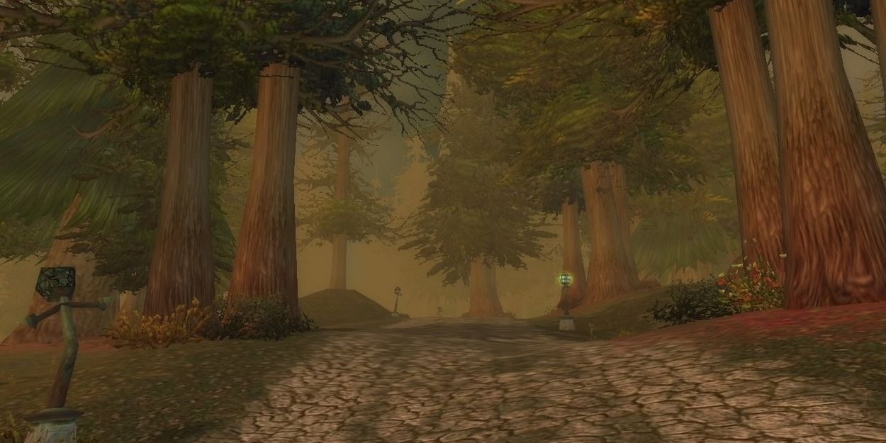World of Warcraft Classic zone, the western plaguelands, main road flanked by trees and ruined lamp-posts.