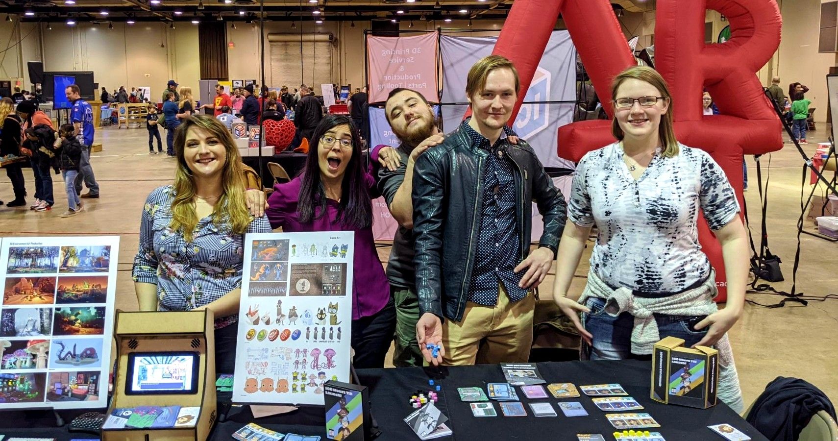 a group of people standing before their created boardgame