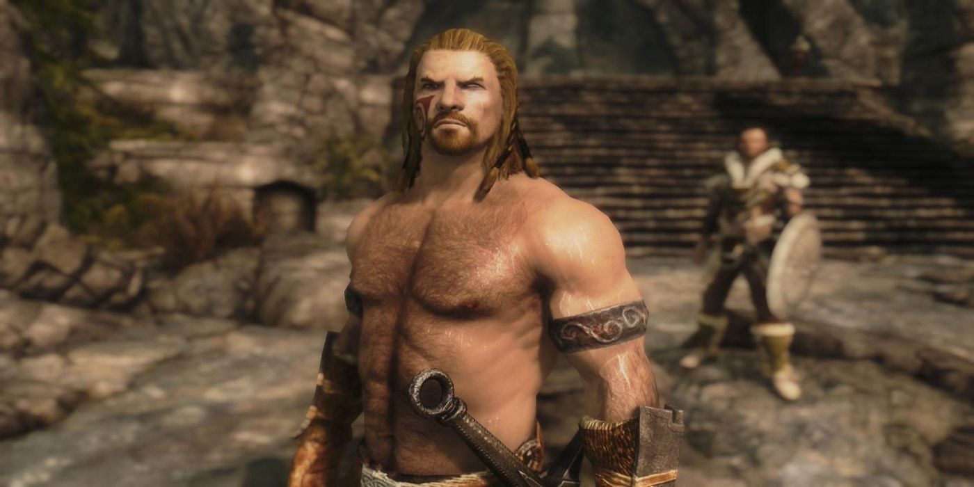 A muscular man, rippling with muscles, glares at the viewer while standing in a stone ruin.