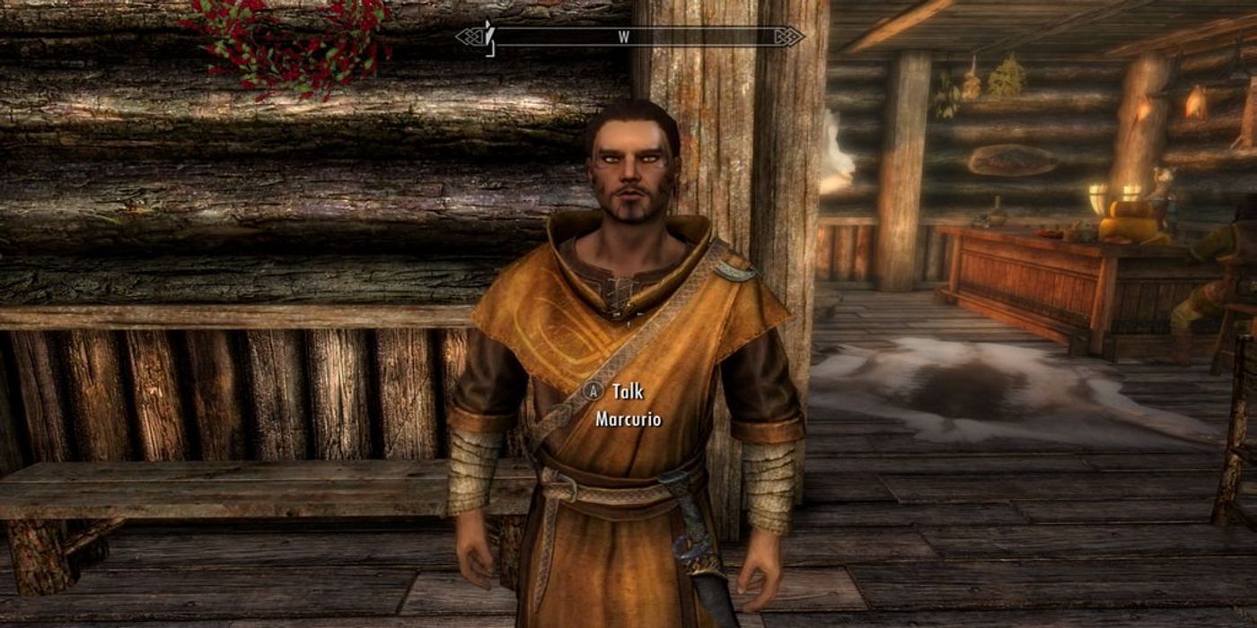 A robed mercenary stands inside an inn, waiting for instructions.