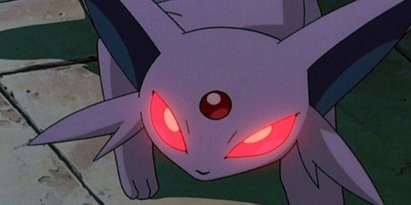 Espeon ready for battle on a rocky cliff in the Pokemon anime