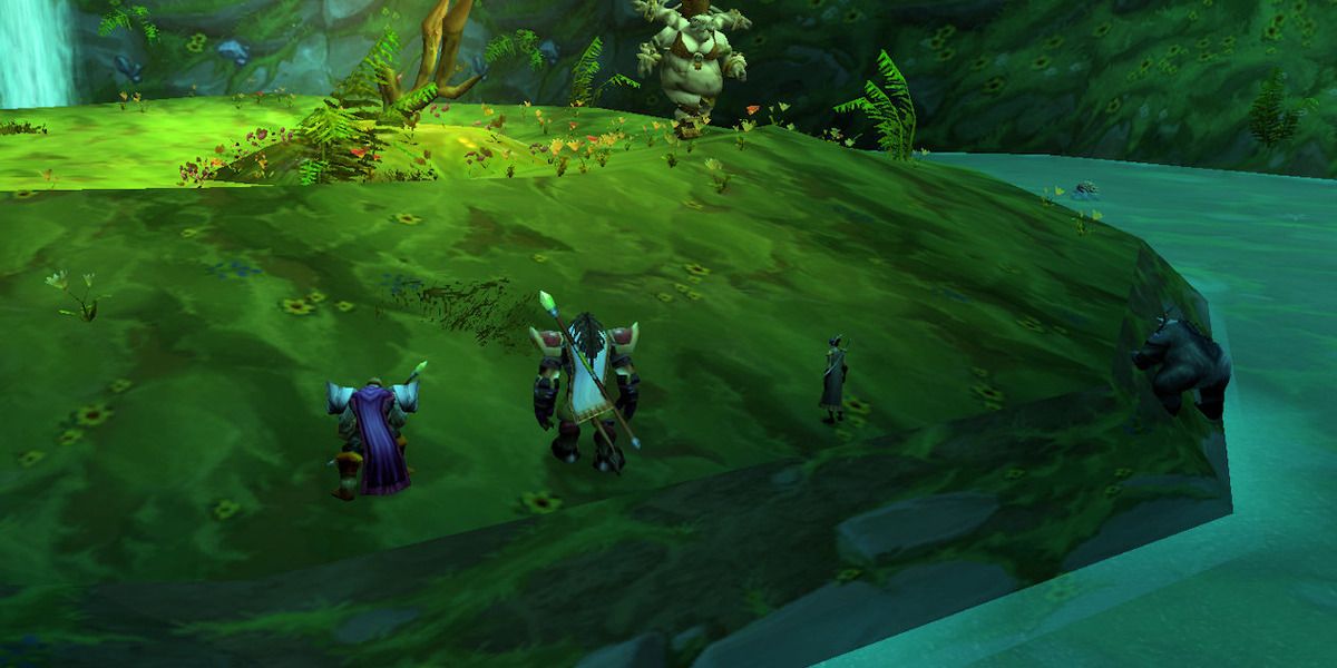 The interior of Maruadon where you fight the Princess in WoW Classic, with three players in the foreground and the princess in the background. 