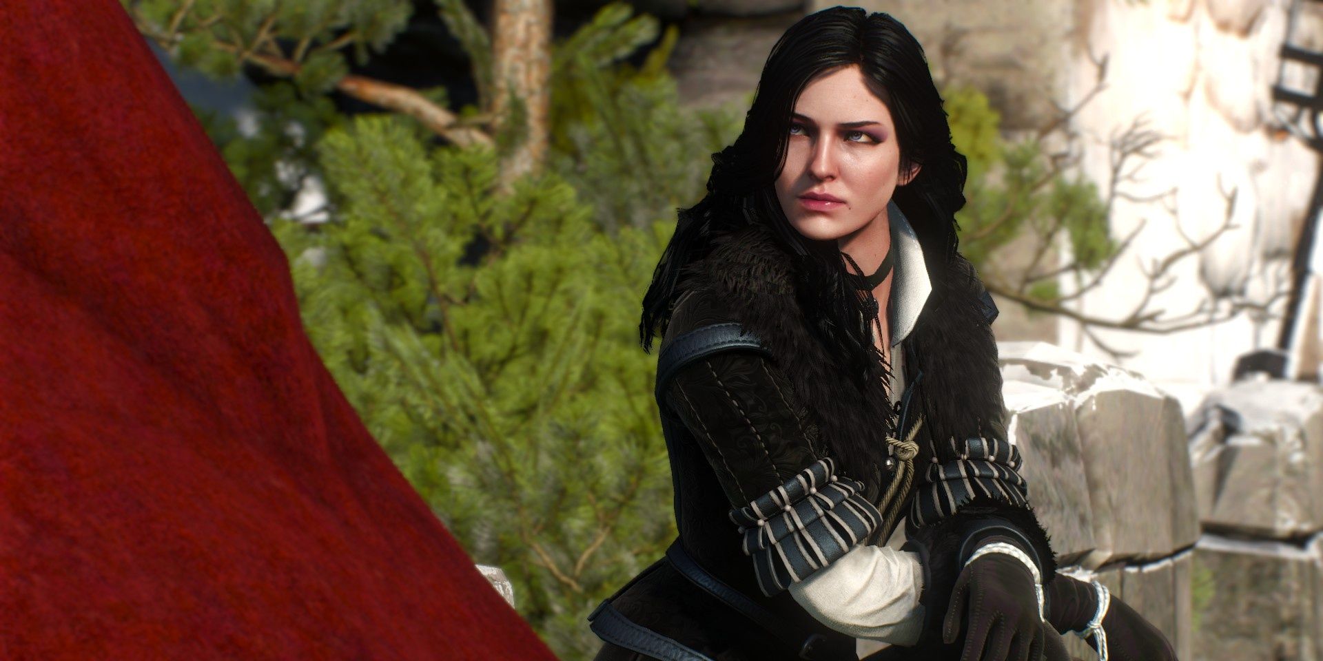 yennefer casting a stern look while sitting with her arms crossed over her lap
