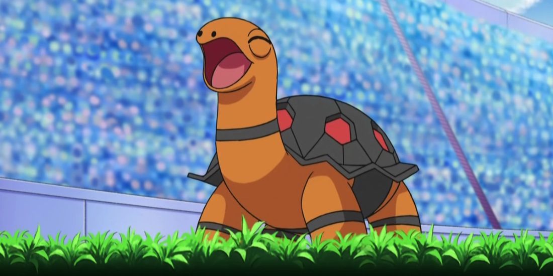Torkoal standing triumphant after battling in a stadium full of people in the Pokemon anime.