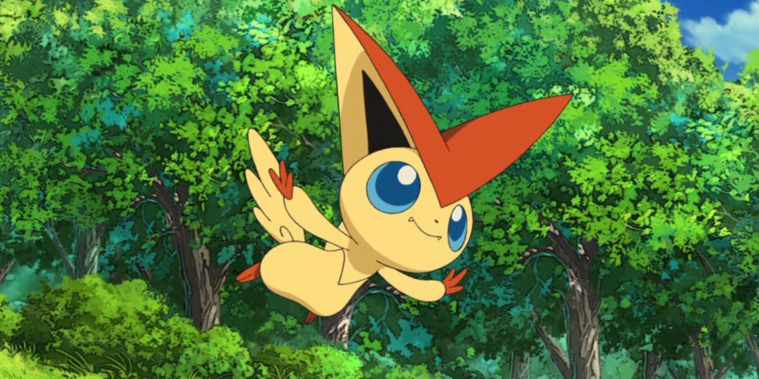 The Pokemon Victini flying happily through a lush, green forest.