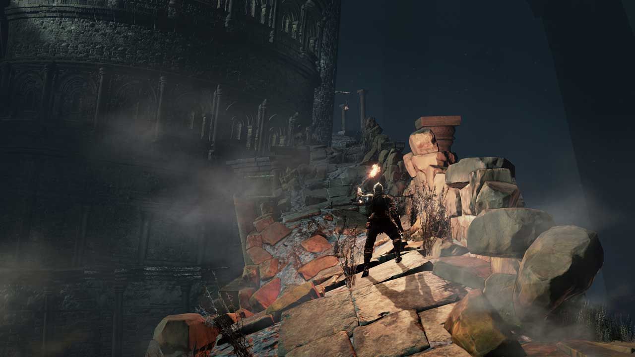 dark-souls-3 knight holding torch on rocky ruins in a dark cave