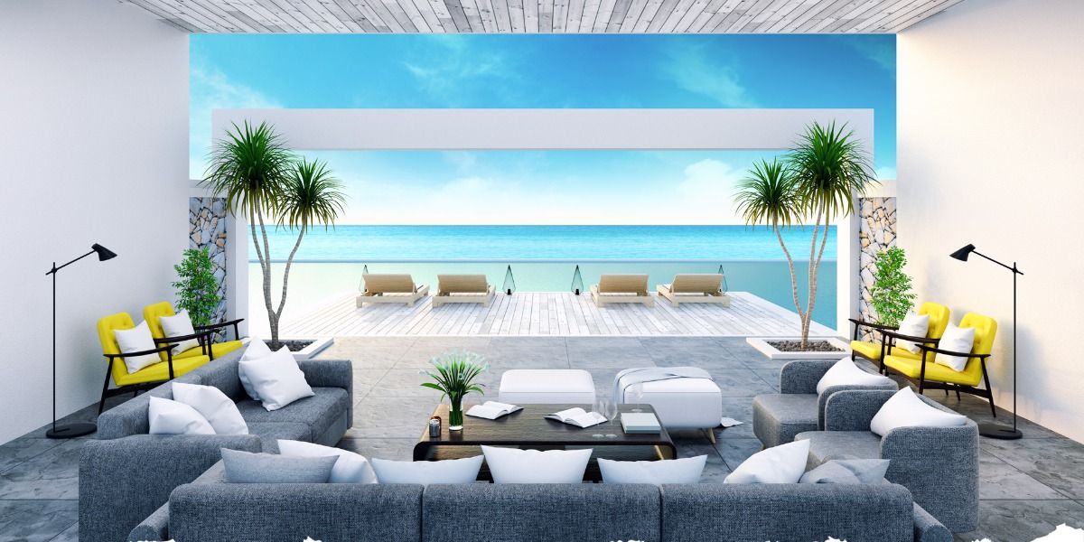 Couches, chairs, and a coffee table decorated with palm trees with a view of the ocean