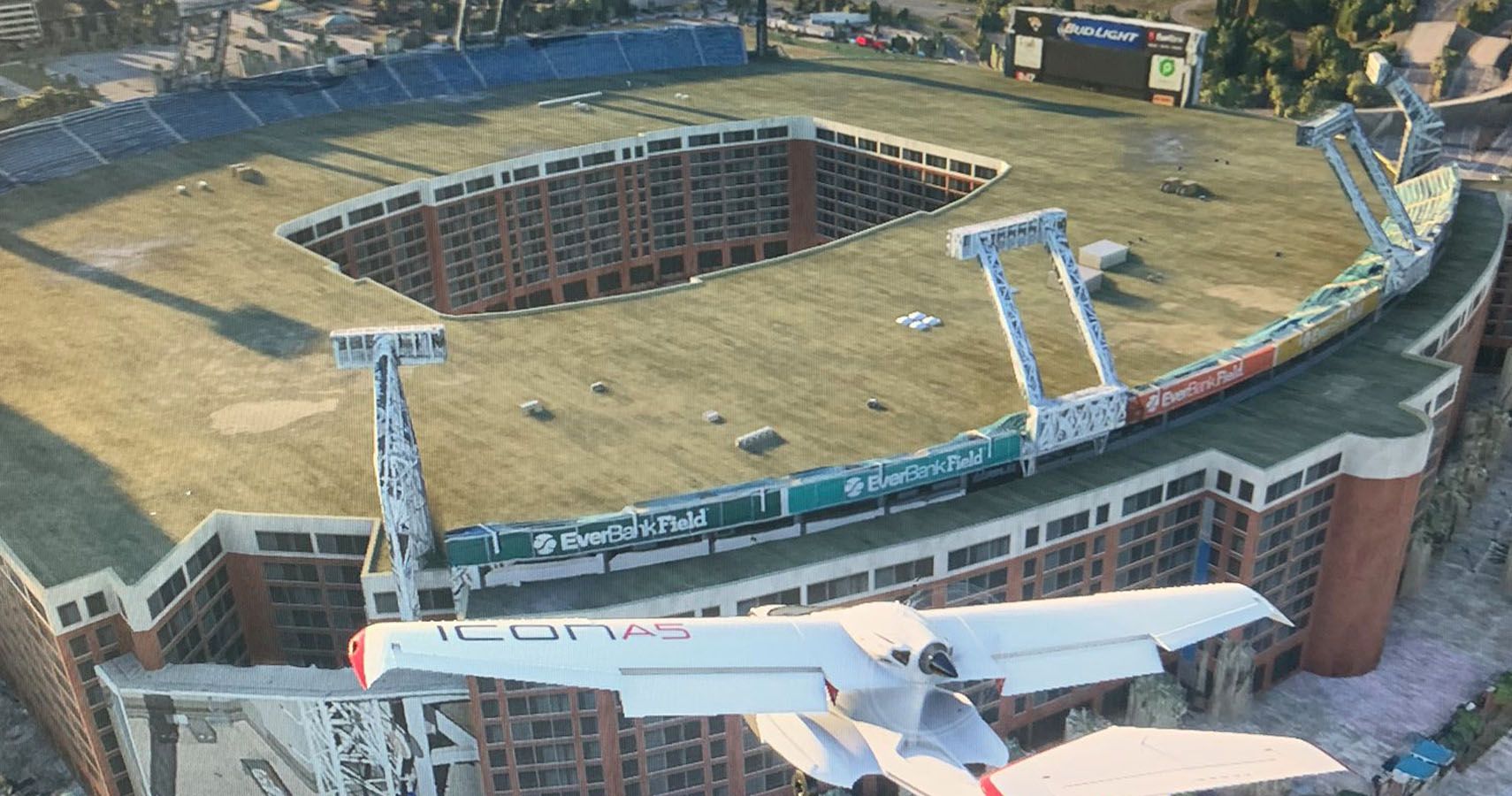 MSFS 2020 Jacksonville Jaguars stadium as a large apartment block with a grass roof and scoreboard.