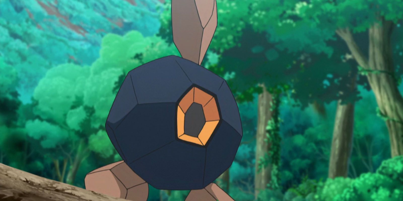 A Roggenrola stands in a forest in the Pokemon Anime.
