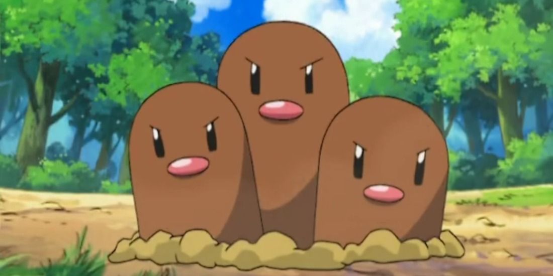 A Dugtrio blocks a forest path in the Pokémon anime