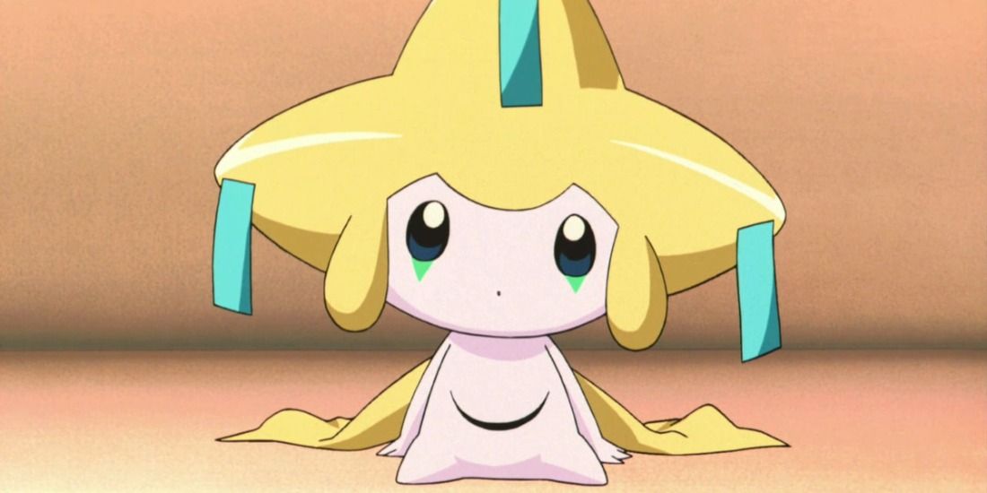 Jirachi looks confused while sitting on a bench in the Pokémon anime
