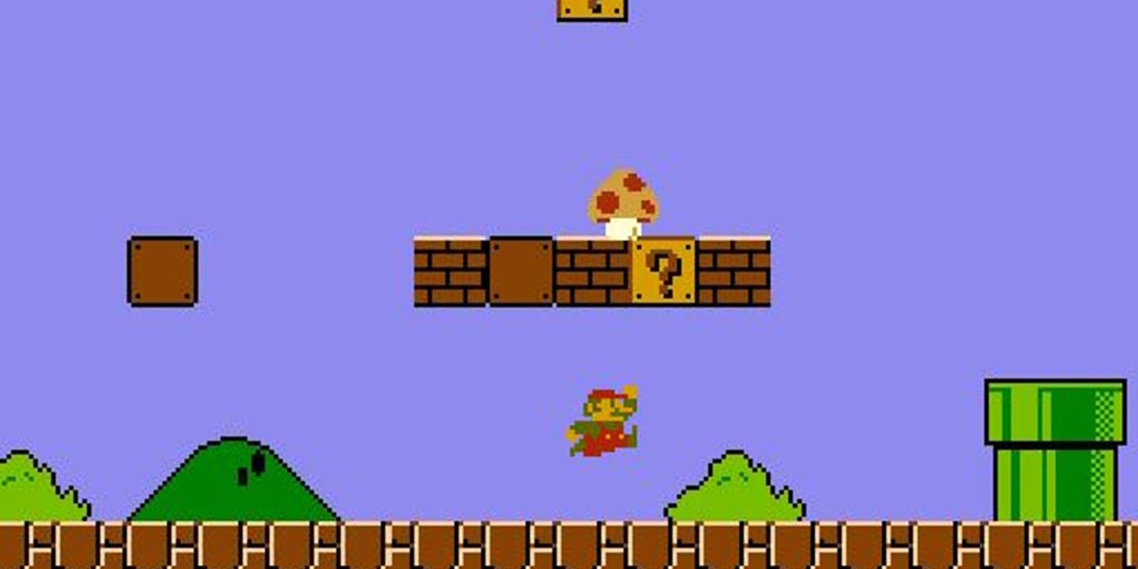 Mario jumping mid-air as a mushroom makes its way down a platform in Super Mario Bros.