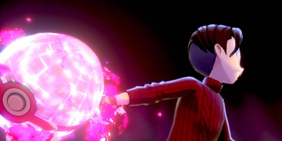 Trainer throwing glowing pink ball in Pokémon Sword & Shield