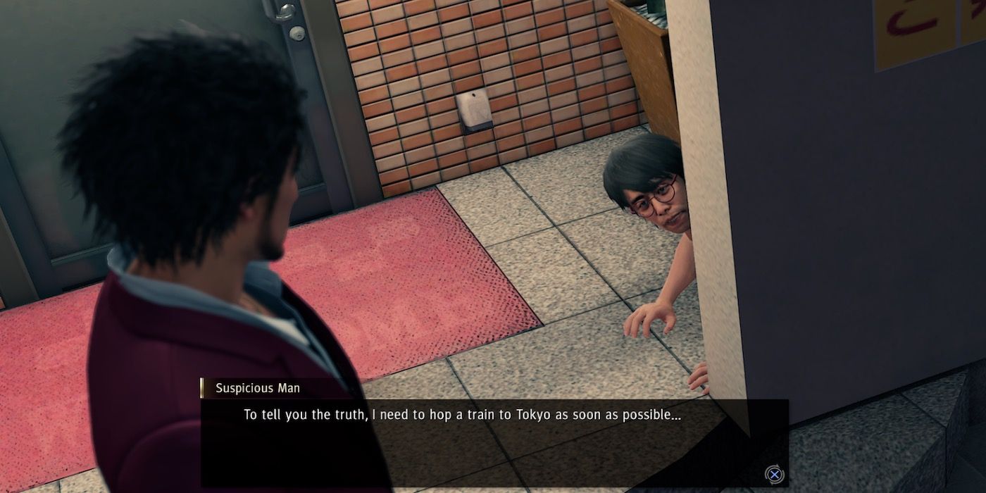 A screenshot of Yakuza: Like A Dragon, showing Awano hiding behind a wall
