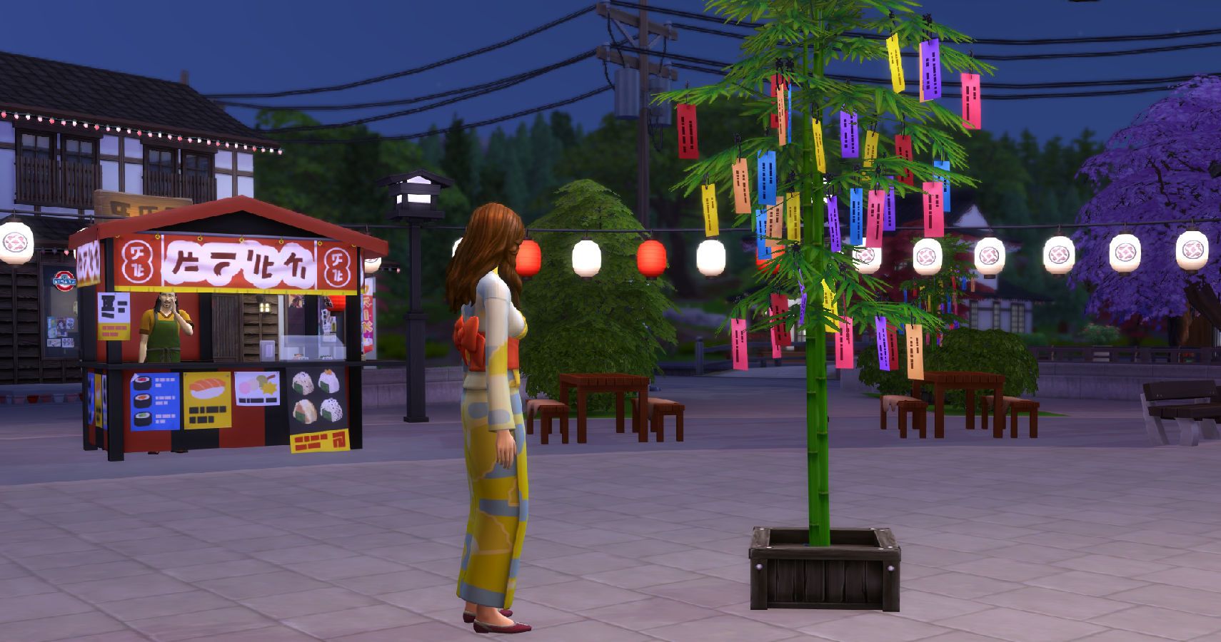 a Tanabata free with a sim standing next to it.